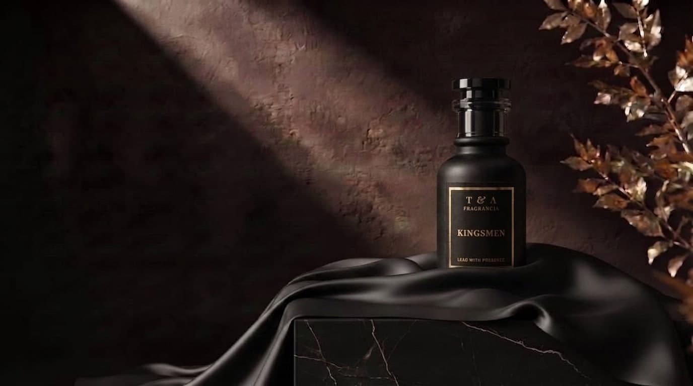A bottle of The Collection by T & A extrait, staged on dark draped fabric